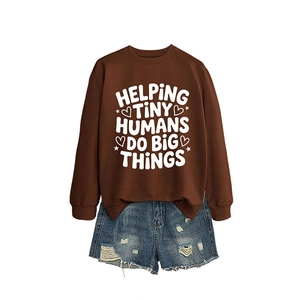 Dark brown crewneck sweatshirt with Helping Tiny Humans print paired with denim shorts