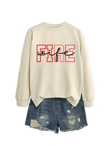 Detail of round neck sweatshirt with FIRE wife print and distressed denim shorts