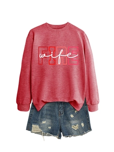 Detail view of Fire Wife graphic print on casual long-sleeved coral sweatshirt and denim shorts