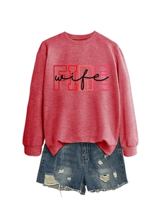 Detail of FIRE wife printed sweatshirt paired with distressed denim shorts