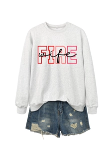 Detail of grey crewneck sweatshirt with FIRE wife print and distressed denim shorts
