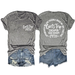 Detail view showing front and back of grey Girls Trip 2026 T-shirt with blue denim shorts