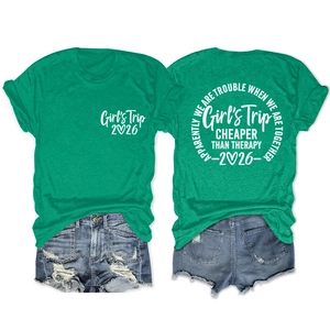 Flat lay of green cotton t-shirt with Girls Trip 2026 white graphic print front and back