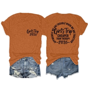 Detail of Girl's Trip 2026 orange cotton t-shirt paired with ripped denim shorts