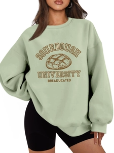 Detail of sage green sweatshirt featuring Sourdough University vintage bread graphic print