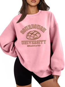 Detailed close-up of pink crewneck sweatshirt with Sourdough University bread graphic