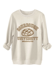 Detail of Sourdough University print on cream round neck sweatshirt with ribbed cuffs