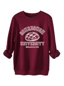 Close-up of ribbed cuffs and screen-printed breaducated graphic on burgundy sweatshirt