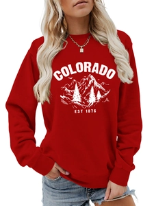 Detail of red crewneck sweatshirt featuring Colorado mountain graphic and ribbed cuffs