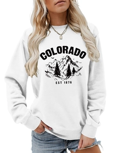 Detailed close-up of white crewneck sweatshirt with vintage black Colorado mountain print