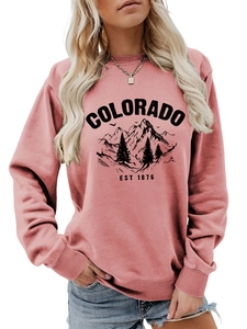 Close-up of pink Colorado crewneck sweatshirt featuring a vintage mountain graphic design