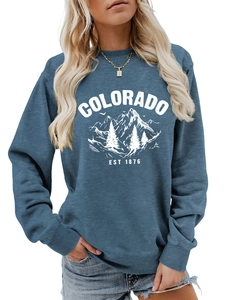 Detail of blue Colorado EST 1876 crewneck sweatshirt with mountain graphic and ribbed cuffs
