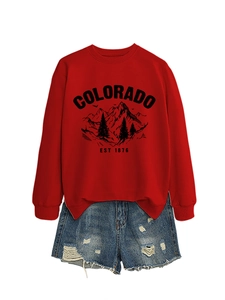 Close-up of red Colorado mountain print sweatshirt paired with frayed denim shorts