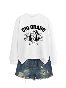Detailed look at white Colorado EST 1876 sweatshirt and distressed denim shorts