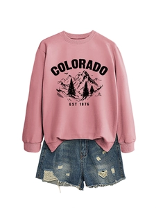 Detail of Colorado EST 1876 rose pink sweatshirt and distressed denim shorts