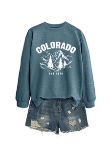 Flat lay of Colorado graphic sweatshirt with distressed denim shorts for a casual outfit