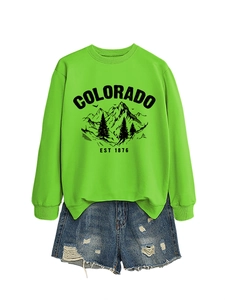 Detail of neon green Colorado sweatshirt paired with distressed blue denim shorts