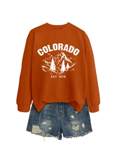 Detail of Colorado Est 1876 print on orange sweatshirt with distressed denim shorts