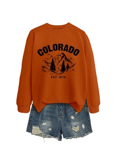 Close-up of rust orange Colorado sweatshirt featuring ribbed cuffs and side slit details