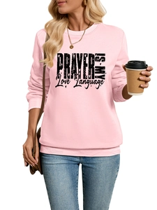 Detailed view of pink sweatshirt cuff and hem with black Prayer Is My Love Language text