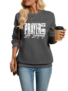 Detail of dark gray sweatshirt featuring white PRAYER IS MY Love Language slogan print