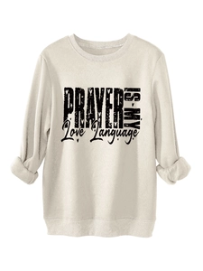 Detail of artistic 'PRAYER IS MY Love Language' black print on cream fleece sweatshirt