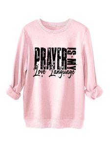 Detail view of pink fleece sweatshirt featuring black PRAYER IS MY Love Language print