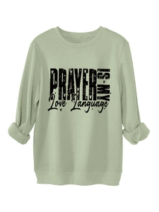 Detail of sage green sweatshirt with black PRAYER IS MY Love Language print
