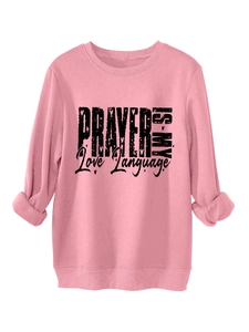 Detailed view of pink fleece sweatshirt featuring Prayer is My Love Language print