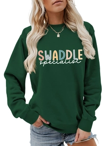 Close-up of deep green sweatshirt showing letter print and ribbed cuffs and hem details