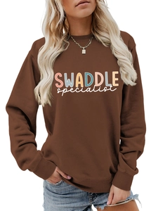 Detail of coffee brown sweatshirt featuring colorful SWADDLE specialist letter print