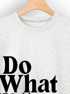 Detail view of heather grey sweatshirt featuring Do What text and ribbed crew neck