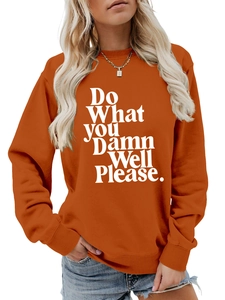 Detail of orange crewneck sweatshirt with white slogan print and soft cotton texture