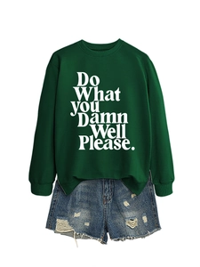 Detailed flat lay of dark green sweatshirt with white text print and frayed denim shorts
