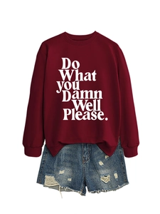 Flat lay of a burgundy crewneck sweatshirt with white text and distressed denim shorts