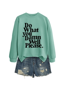 Detail of mint green sweatshirt with Do What You Damn Well Please print and denim shorts