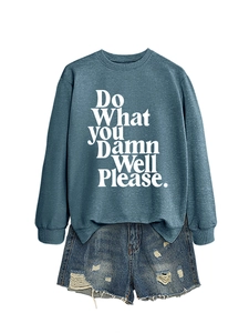 Detail of blue-grey sweatshirt with 'Do What You Damn Well Please' print and ripped denim shorts