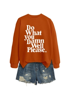 Flat lay of an orange crewneck sweatshirt with text and ripped denim shorts set