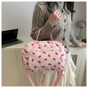 Detail view of pink corduroy strawberry print tote bag with adjustable shoulder strap