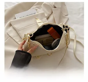 Detailed interior view of creamy white patent leather handbag showing its large capacity