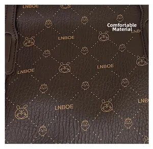 Detailed macro view of dark brown pebbled leather texture with bunny and chick patterns