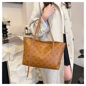 Detail of vintage print tote bag with brown leather straps and bunny pattern