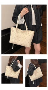 Close-up of litchi texture leather tote bag featuring a cute animal monogram print