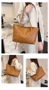 Detail of a brown plaid tote bag featuring animal prints and a lychee texture finish