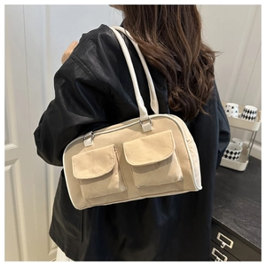 Beige canvas shoulder bag with dual front pockets and white faux leather trim details