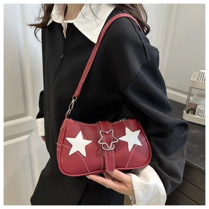 Detail of red pebbled leather shoulder bag with white stars and Y2K metallic buckle