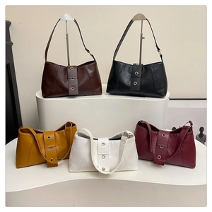 Detailed display of vintage hobo bags in five colors with metal eyelet strap design