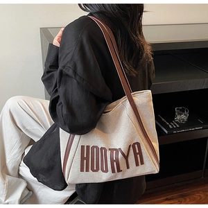 Detailed view of the HOORYA canvas tote bag with brown leather straps for daily commute