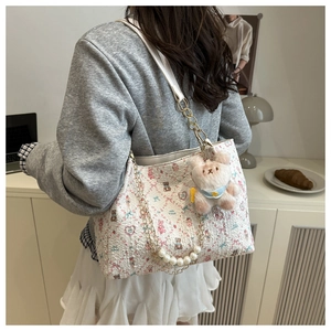 Détail du cabas floral avec motifs d'ours roses, chaîne perlée et breloque en peluche