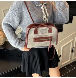 Detail of vintage matte shoulder bag with brown leather trim and silver metal hardware